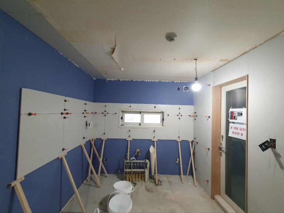 나무 지지대와 전등이 설치된 공사 중인 실내