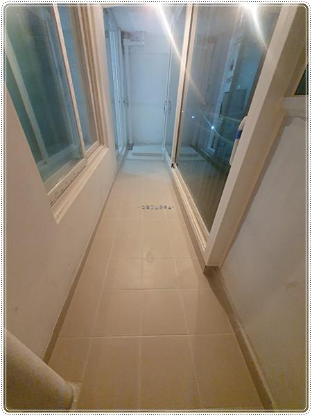 베이지색 타일 바닥과 유리 패널 도어가 설치된 실내 모습