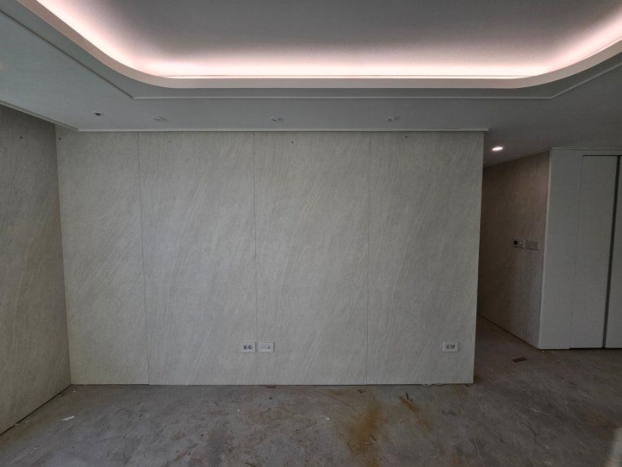 곡선형 LED 조명과 베이지색 마감재가 적용된 벽면