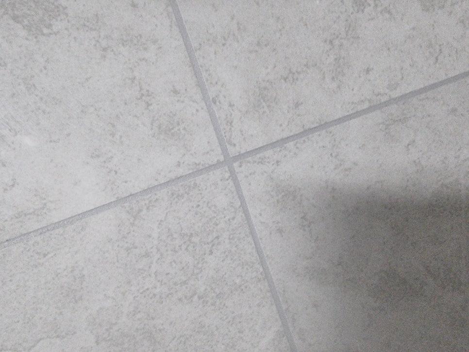 회색 타일 바닥과 흰색 벽지가 만나는 지점