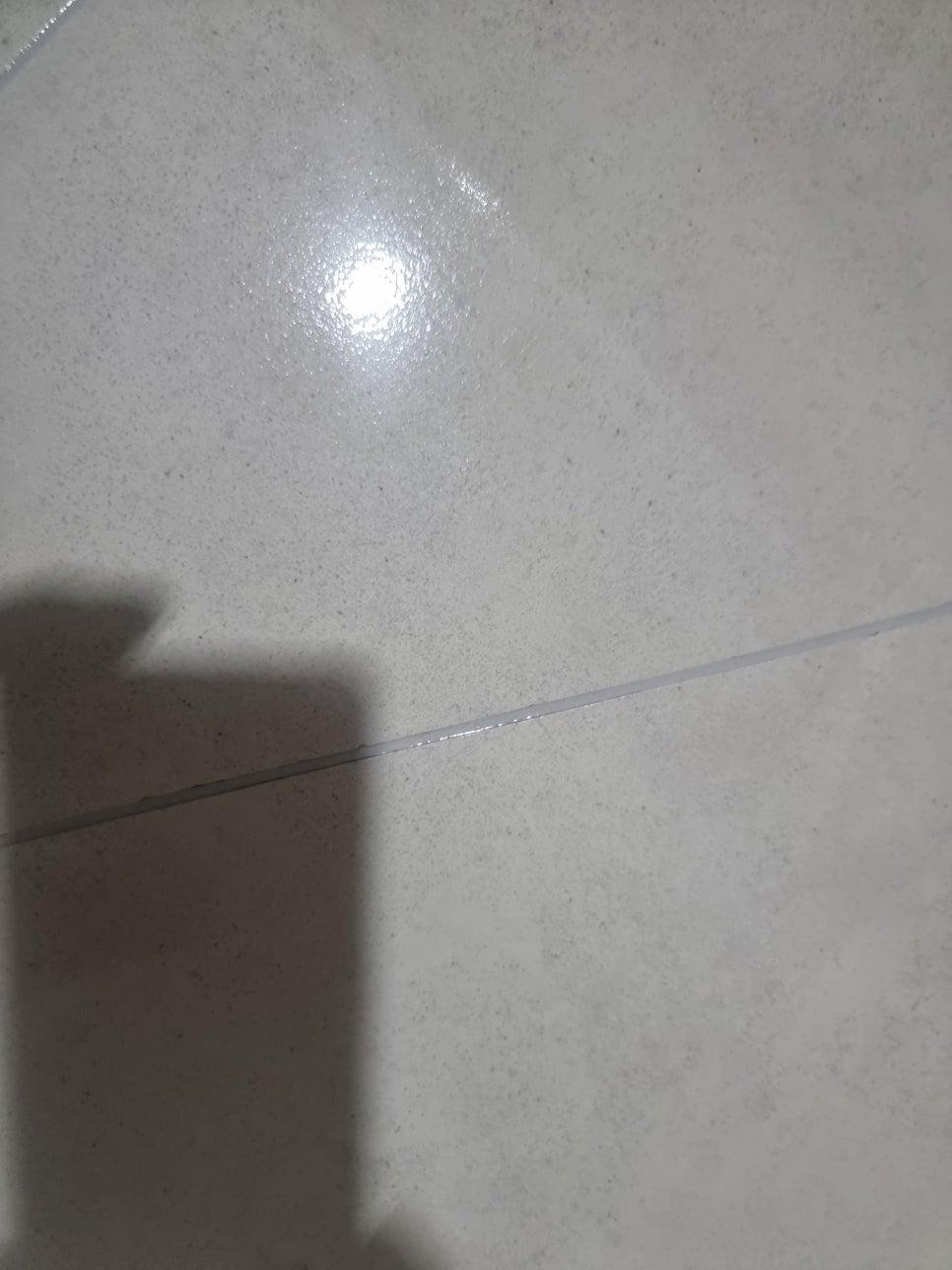 빛이 반사되는 흰색 타일 바닥 근접샷