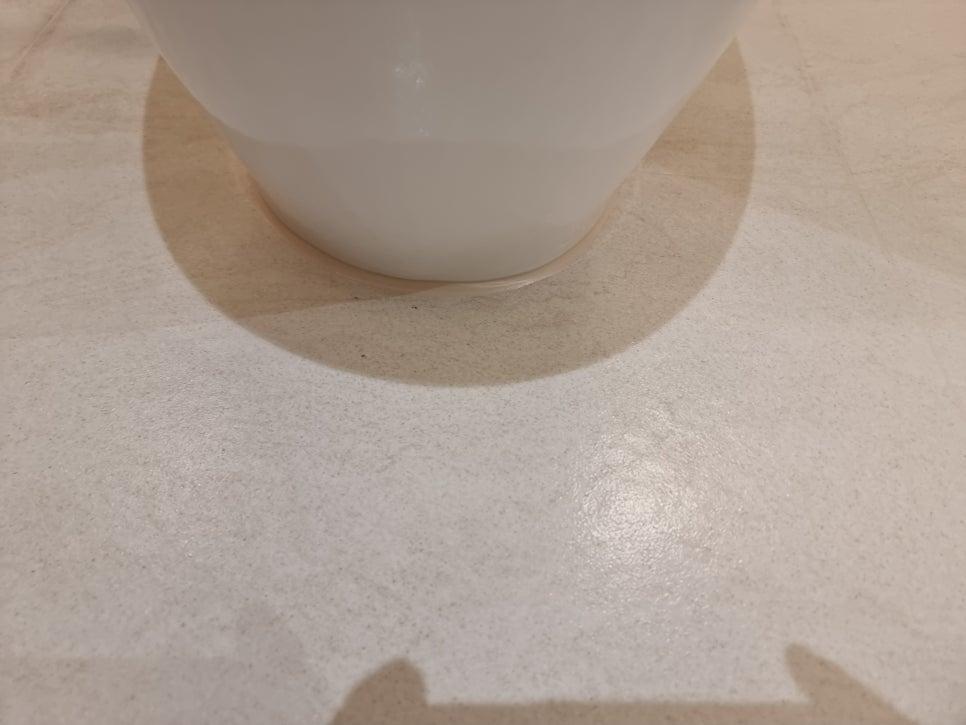 베이지색 바닥 위로 보이는 원통형 물체