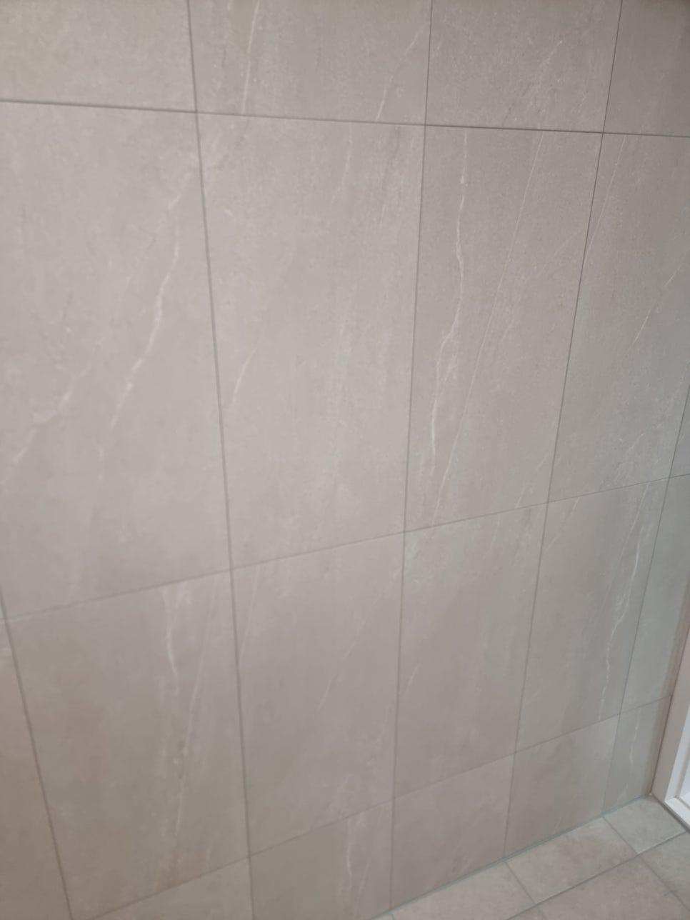 흰색 줄무늬가 있는 베이지색 타일 벽면