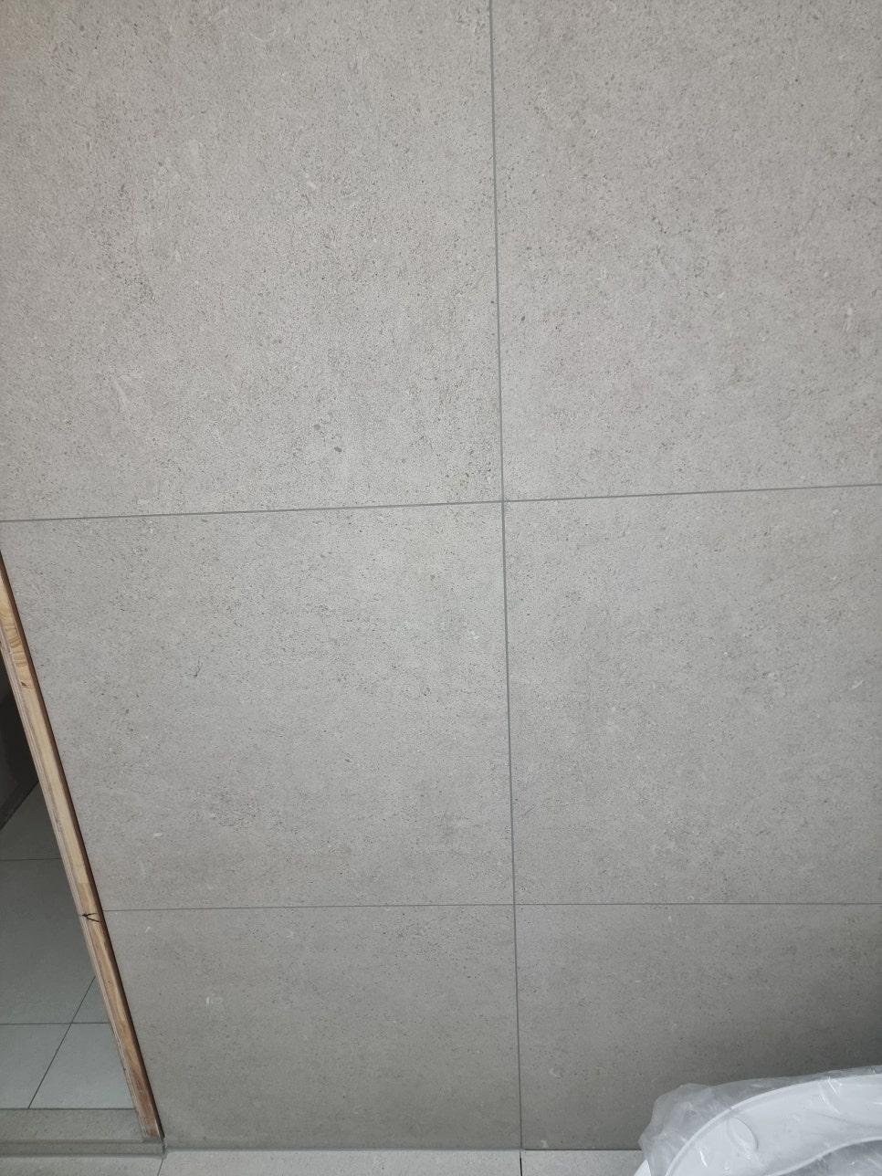 회색 타일 벽면과 나무 프레임 문