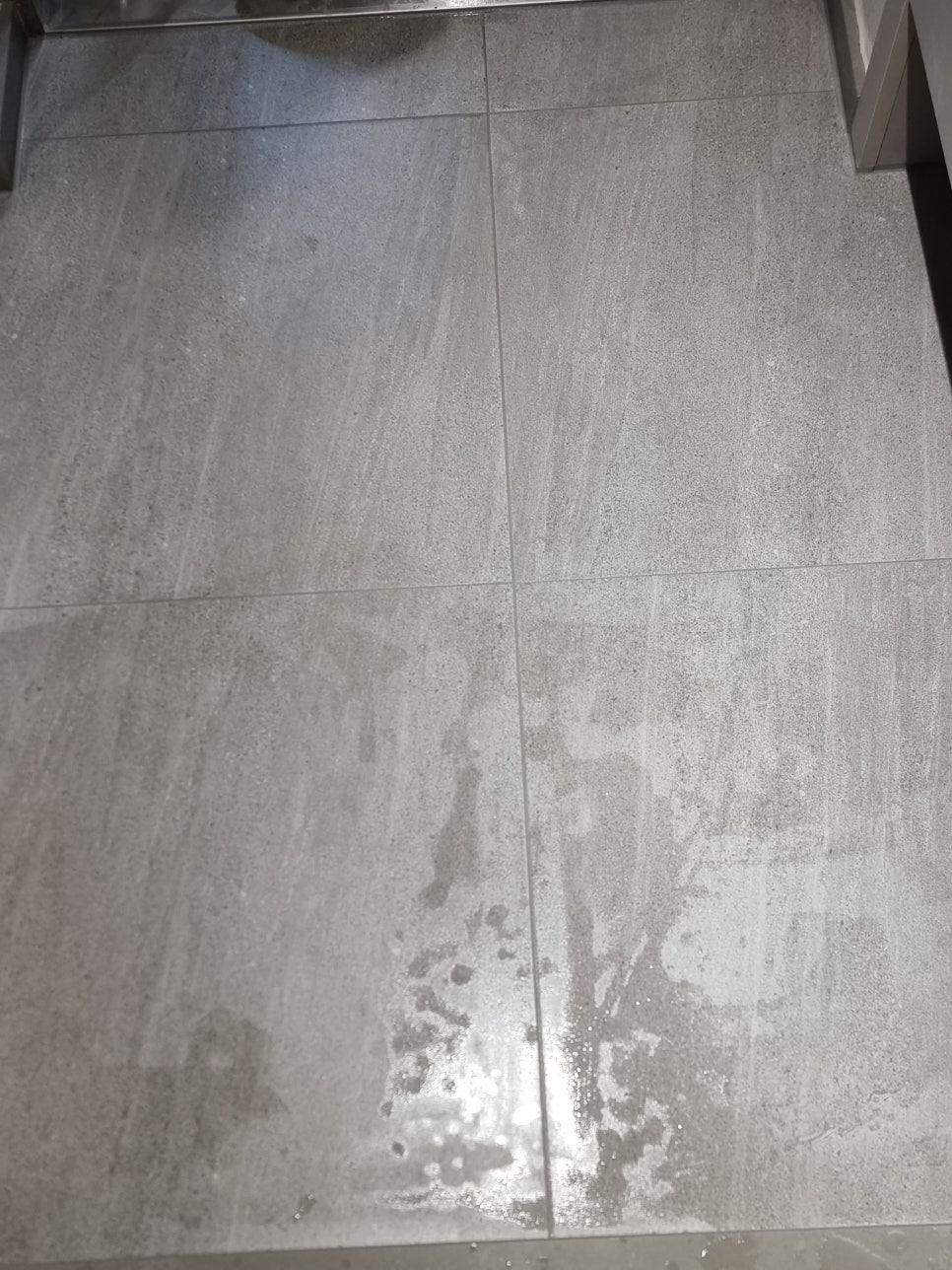 물渍와 반짝임이 보이는 회색 타일 바닥