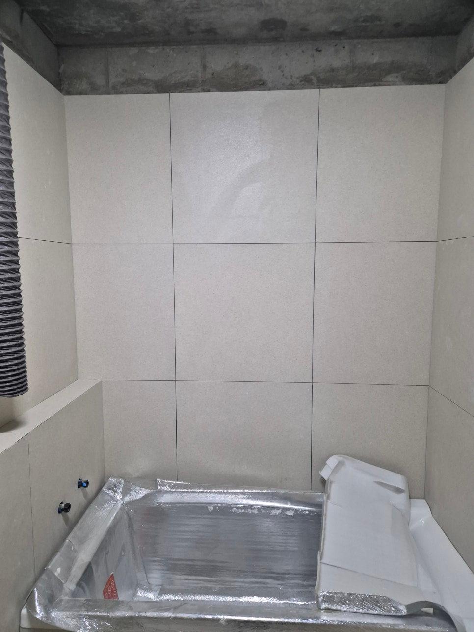 레이저 수평을 맞추며 진행 중인 타일 시공