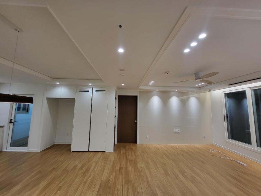 화이트 샷시로 개방감을 높인 넓은 거실 모습
