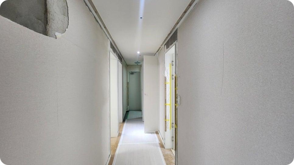 노출된 콘크리트와 흰색 마감재가 섞인 복도