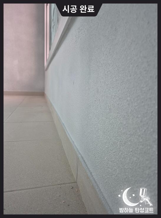 벽면 마감재와 바닥 타일이 밀착된 근접 촬영 컷