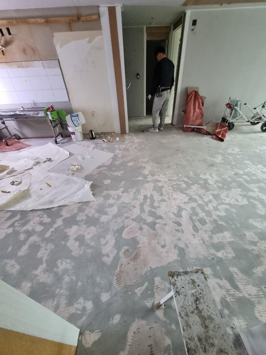 도배 작업과 바닥 보호지가 깔린 분주한 현장