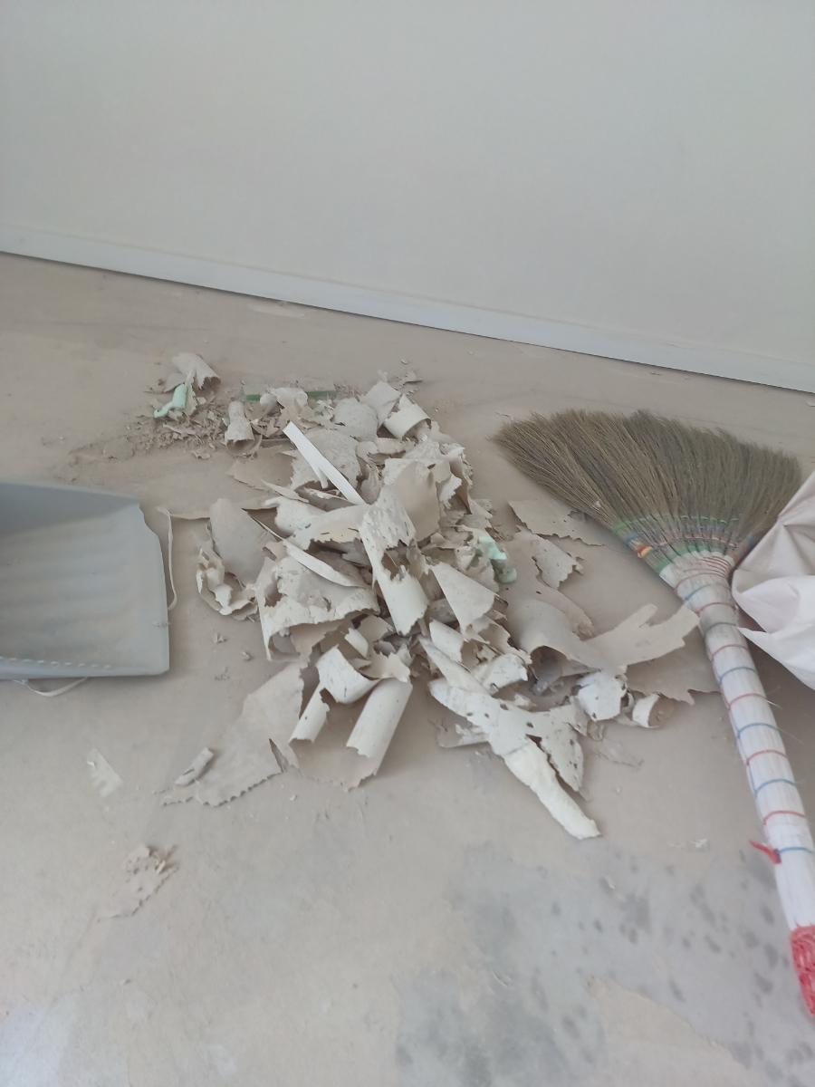 바닥의 도배 파편을 정리하는 과정