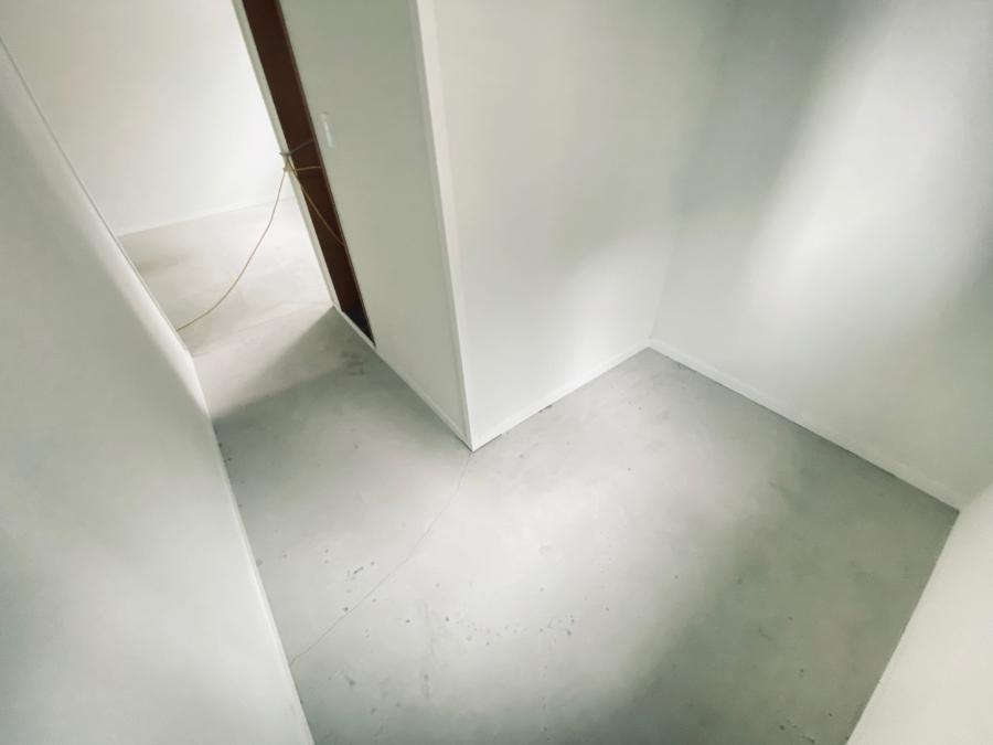 케이블이 놓인 회색 바닥의 텅 빈 복도