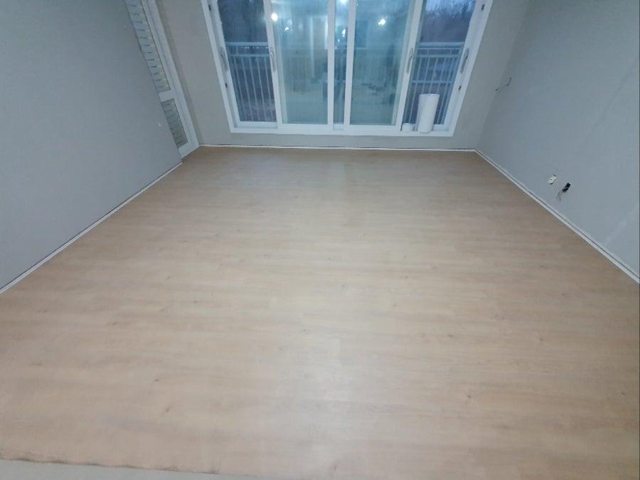 회색 벽면과 목재 바닥재가 설치된 실내 모습