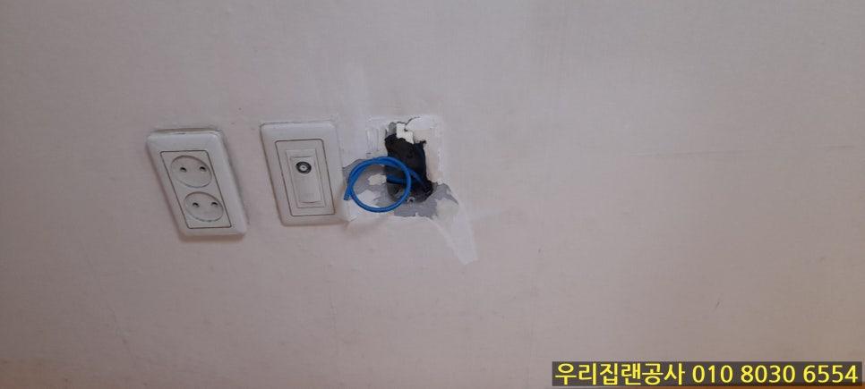 파손된 벽 속 전선이 보이는 소켓 주변 모습