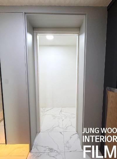회색 벽면과 마블 타일 바닥이 있는 복도 공간
