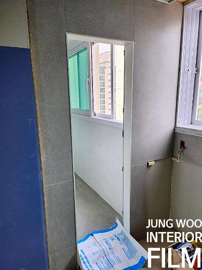 회색 타일 마감의 벽면과 바닥이 보이는 복도