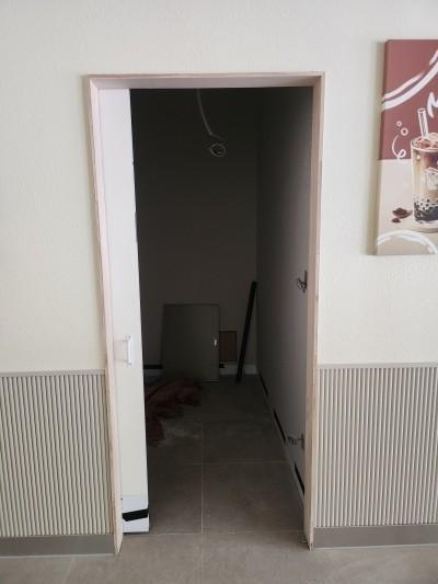 흰색 도어 프레임과 라인 패턴 벽지가 맞닿은 실내