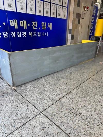 파란색 벽면과 금색 테두리 구조물이 배치된 공간