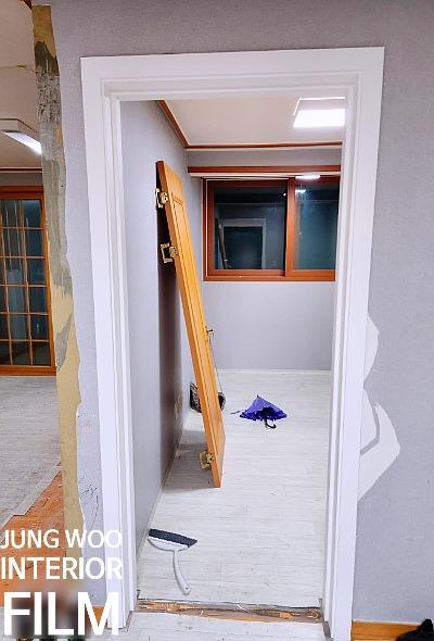 흰색 타일 바닥과 흰색 프레임 창문이 보이는 복도