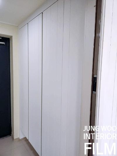 벽면을 가득 채운 깔끔한 화이트 수납장 복도