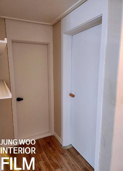 베이지색 벽면과 나무 마루가 깔린 복도 문