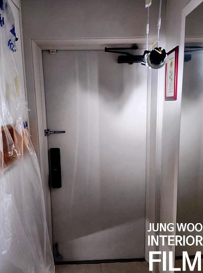 보양 작업 후 필름 시공이 진행 중인 현관 공간