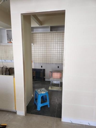 타일 벽면과 빈 캐비닛이 있는 공사 현장