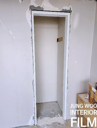 흰색 테두리가 잡힌 문틀과 콘크리트 바닥