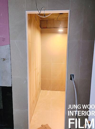 황금색 타일 마감이 돋보이는 욕실 공사 현장