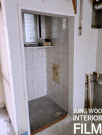 배수구와 창문이 있는 타일 마감 공간