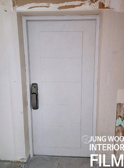 마감이 벗겨진 흰색 도어와 금속 손잡이