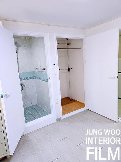 파란 타일 샤워실 옆 수납장이 위치한 공간
