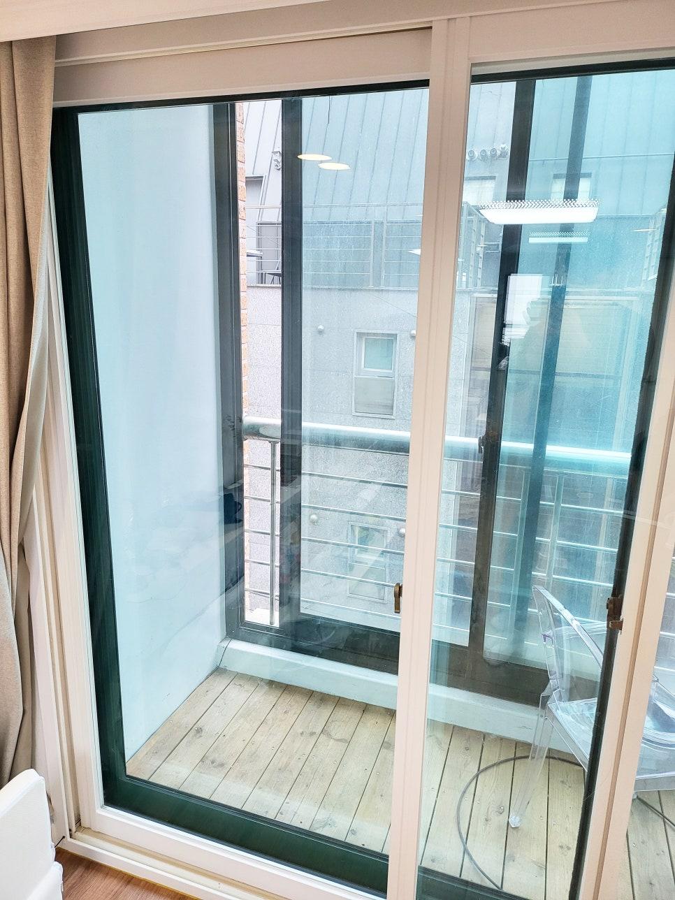 발코니로 연결되는 슬라이딩 창호와 화이트 문틀
