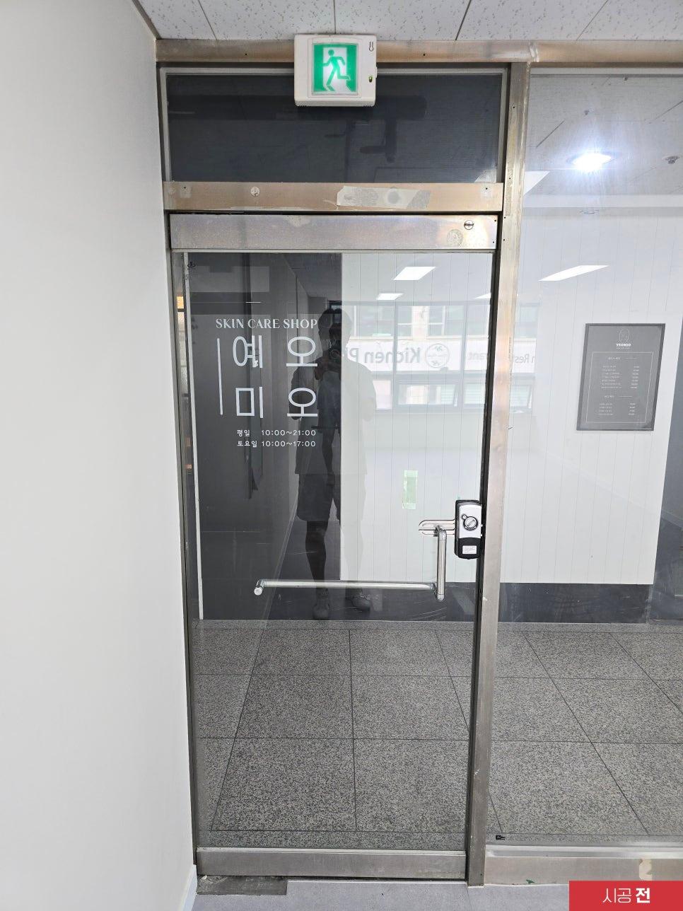 영업 시간 표시가 붙어 있는 시공 전의 유리문