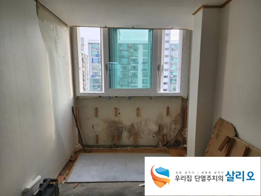 창문 근처 벽면 마감 작업 중인 실내