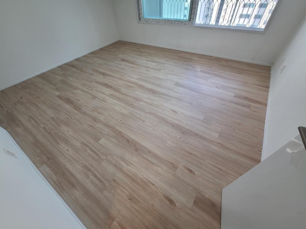 금속 난간 창문이 있는 넓은 공간의 목재 바닥재