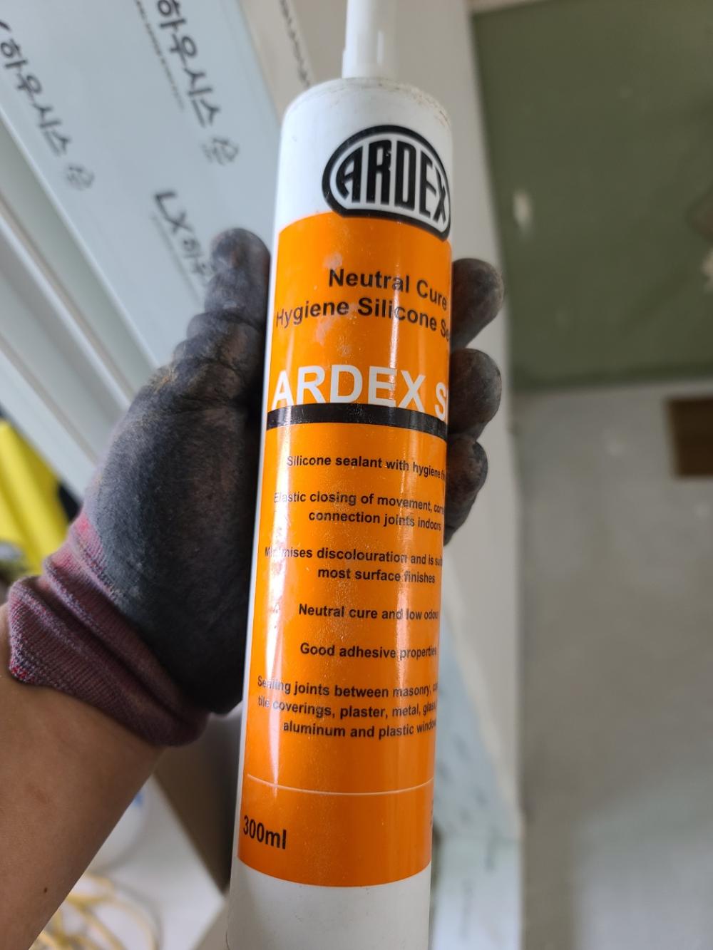 손에 든 ARDEX 중립경화 위생 실리콘 제품