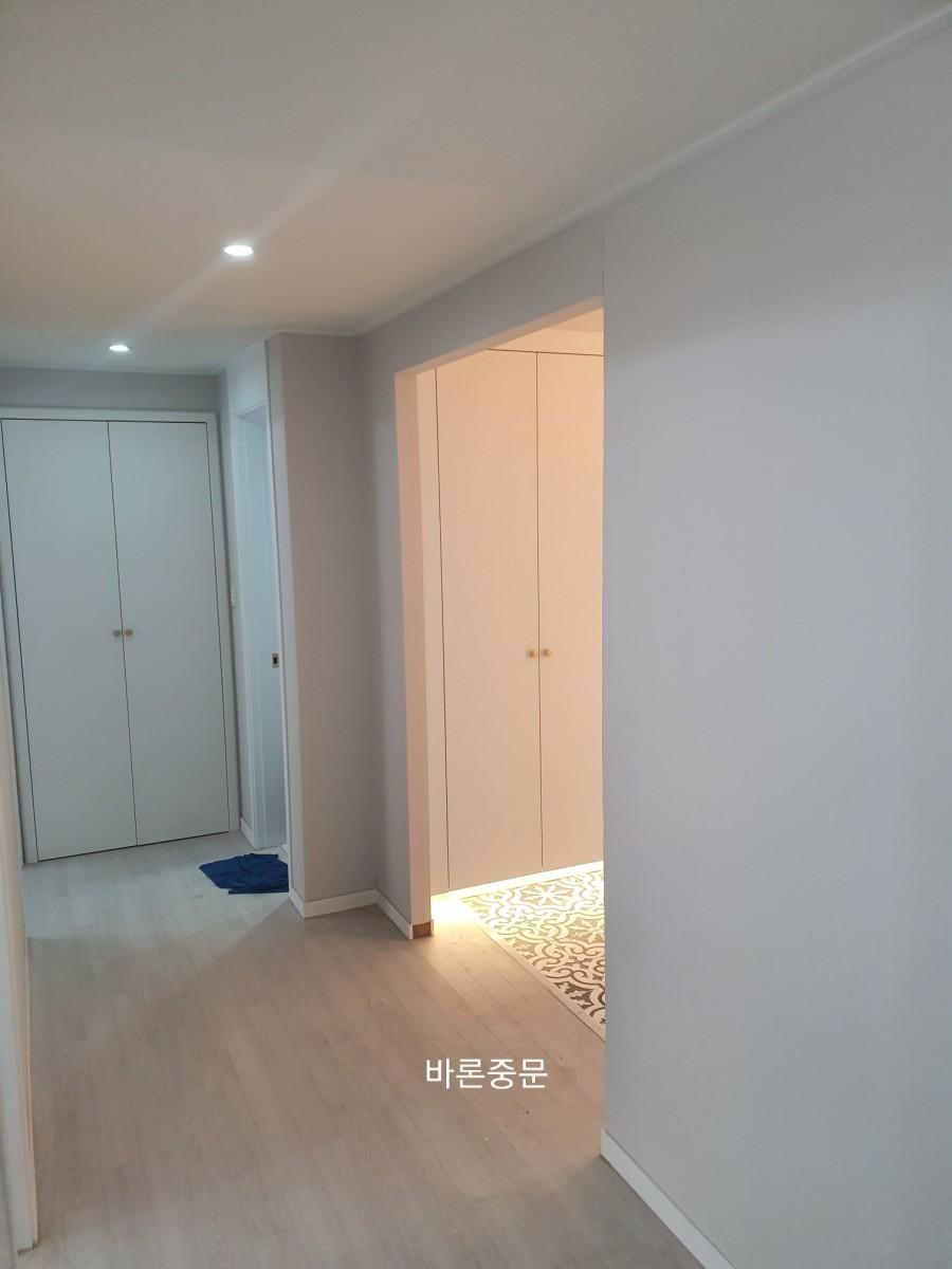 밝은 톤으로 마감된 현관 벽과 바닥 표면