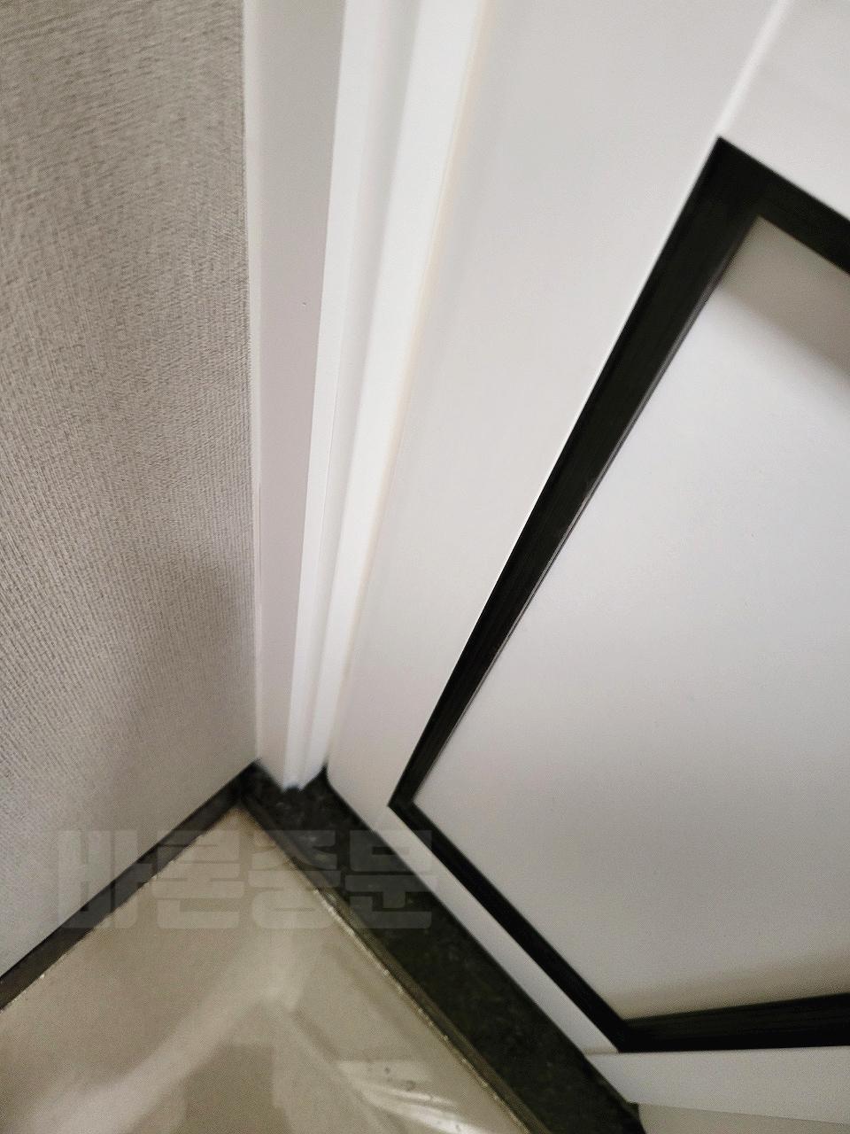 흰 벽면과 검은색 테두리 도어가 배치된 작업 모습