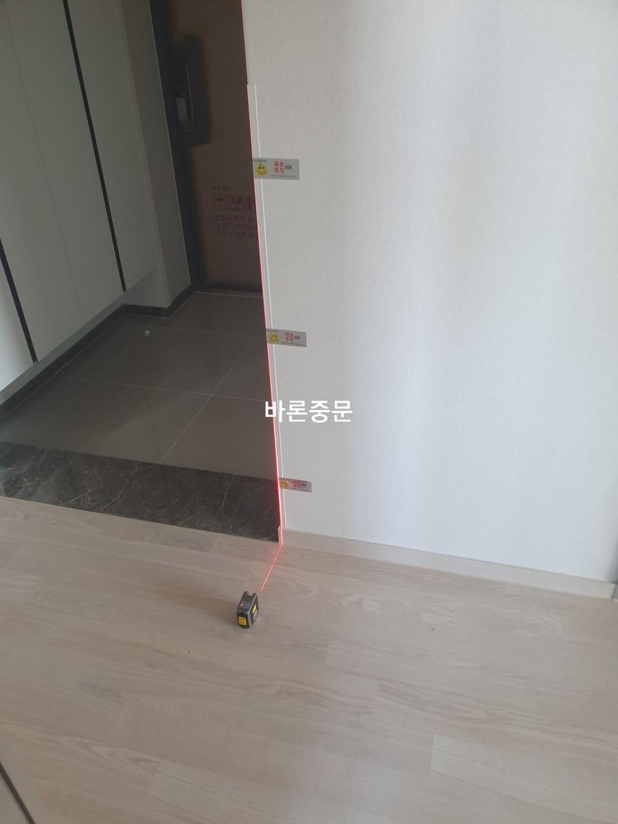 레이저 레벨기로 수평을 측정 중인 벽면