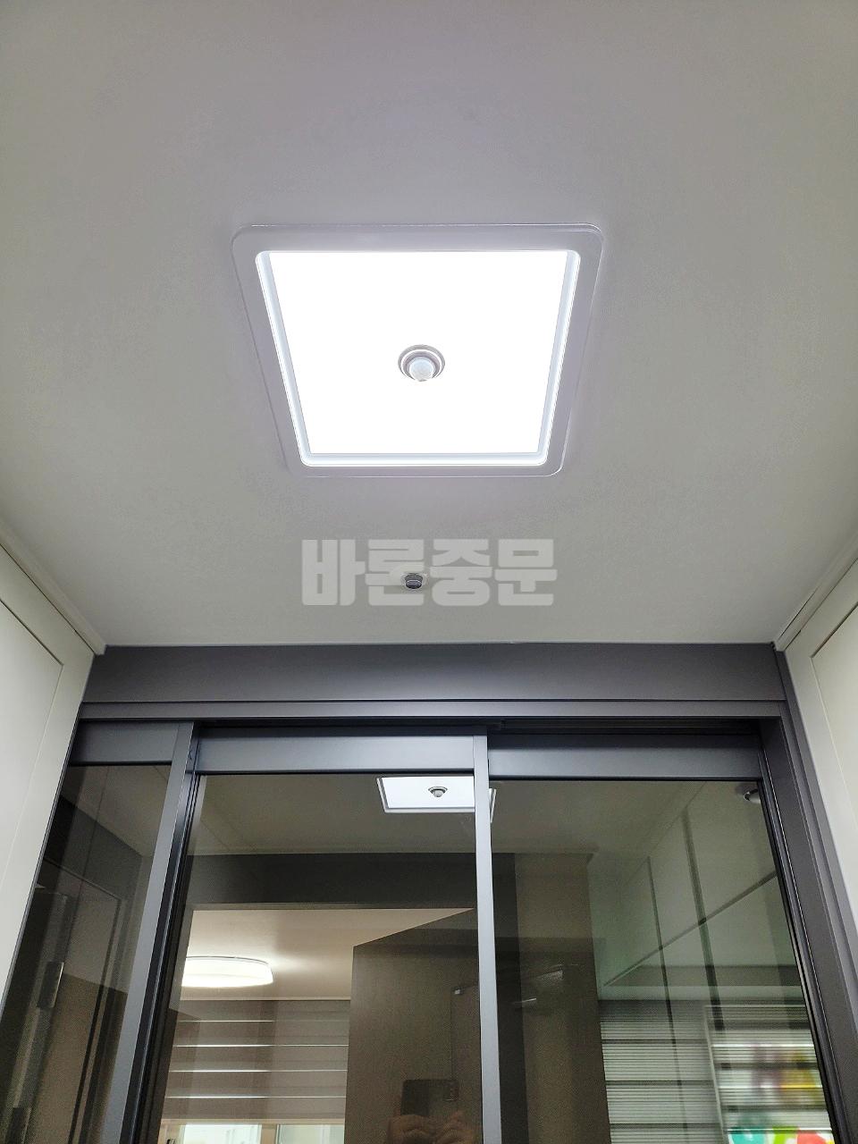 천정등 빛이 은은하게 비치는 회색 유리문