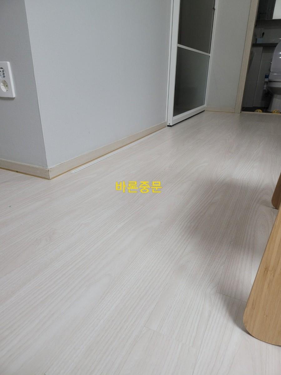밝은 목재 바닥과 베이지색 베이스보드가 어우러진 내부 공간