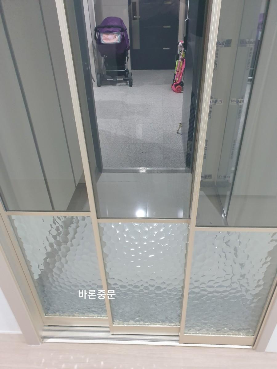 회색 타일 바닥의 현관 중문 설치 모습