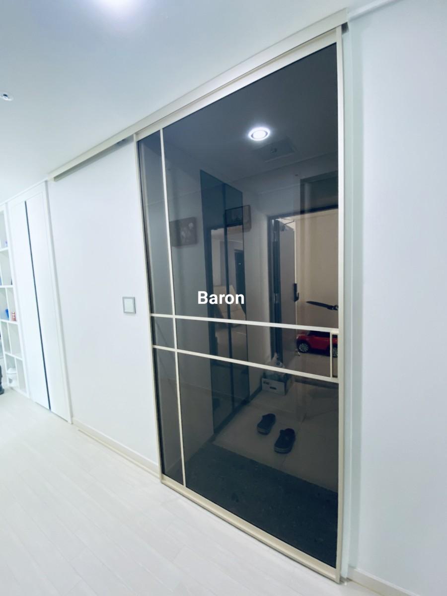 브론즈 유리에 실내가 반사된 도어 모습