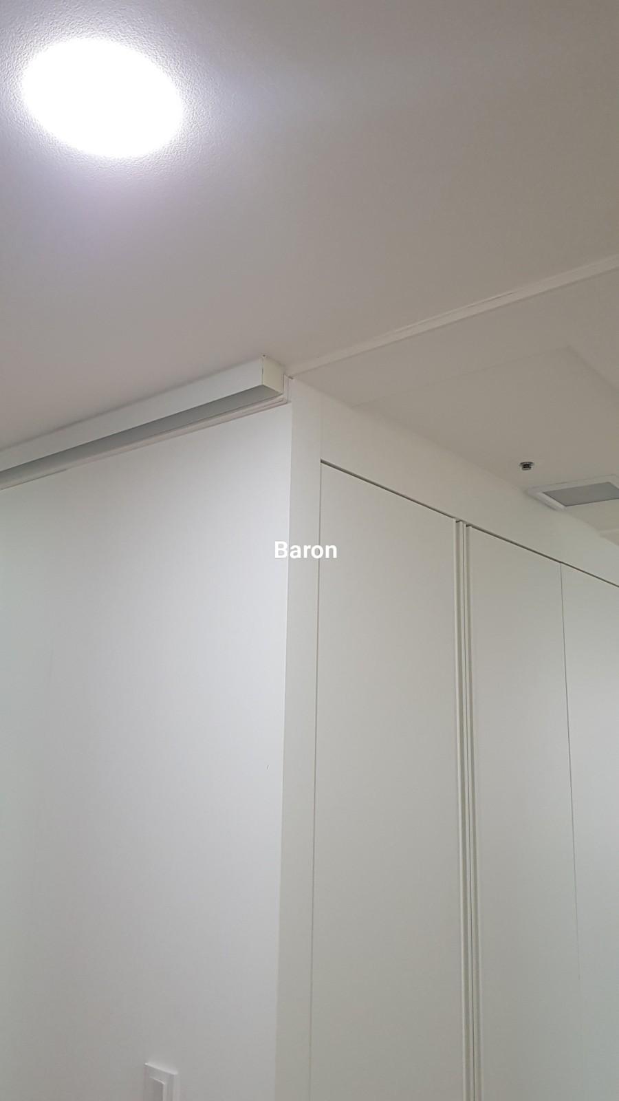 천장 조명과 화이트 수납장이 보이는 상부 공간
