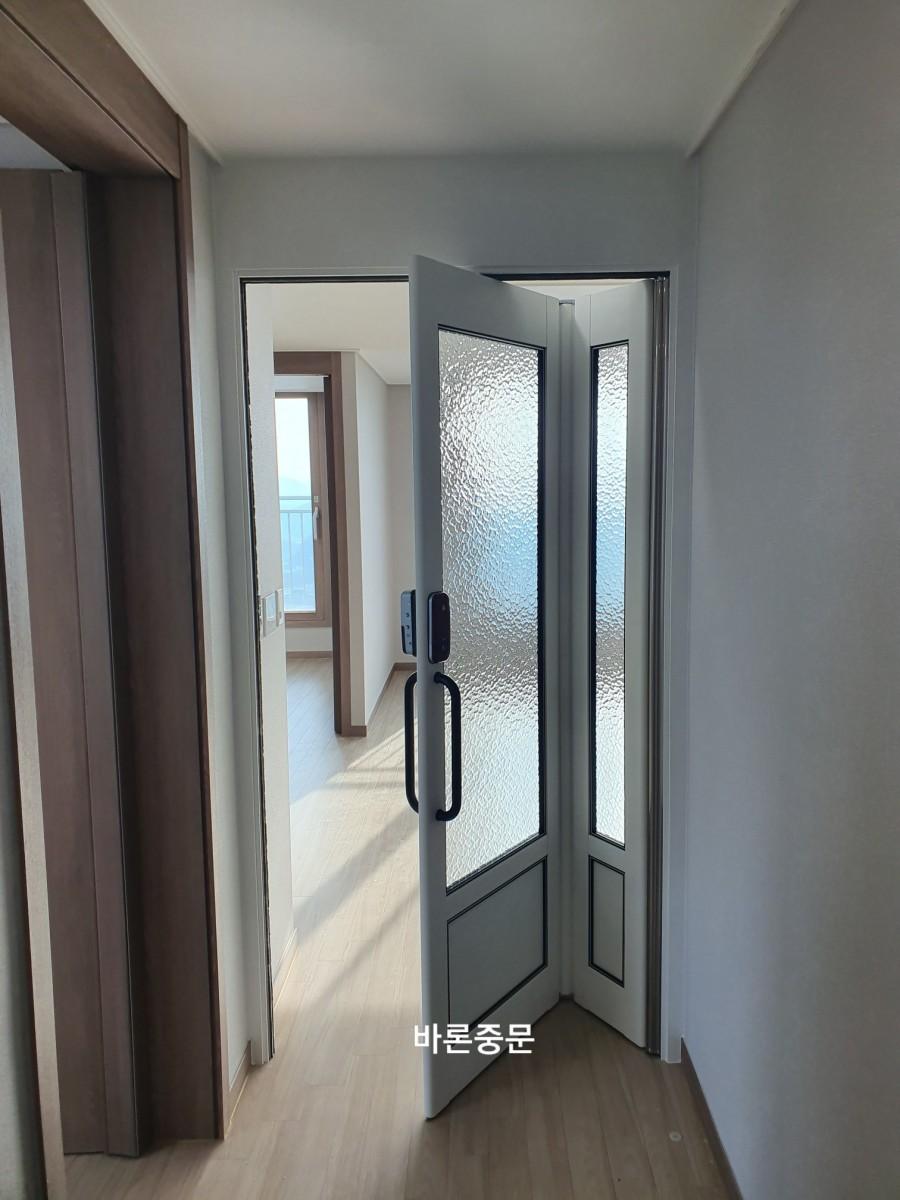 열린 상태의 회전식 문과 목재 바닥