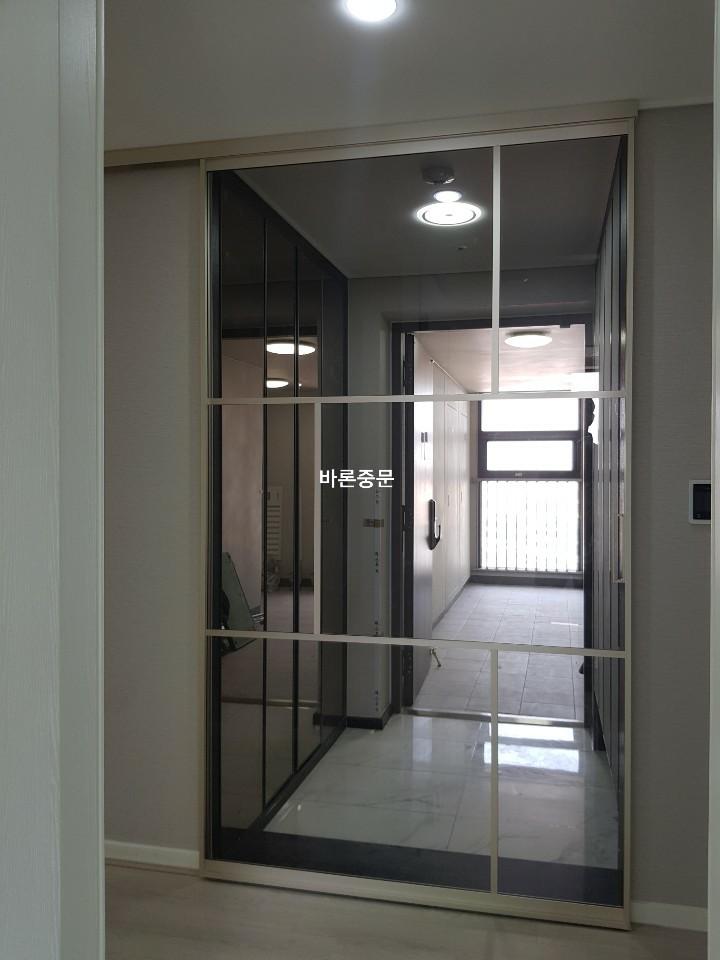 흰색 타일 바닥 위에 설치 완료된 슬라이딩 유리문