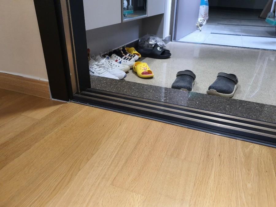시공 전 타일 바닥과 수납장이 보이는 현관