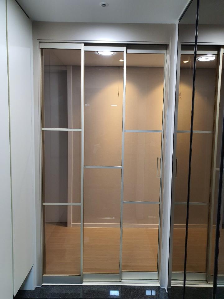 금색 프레임과 조명이 어우러진 드레스룸 공간