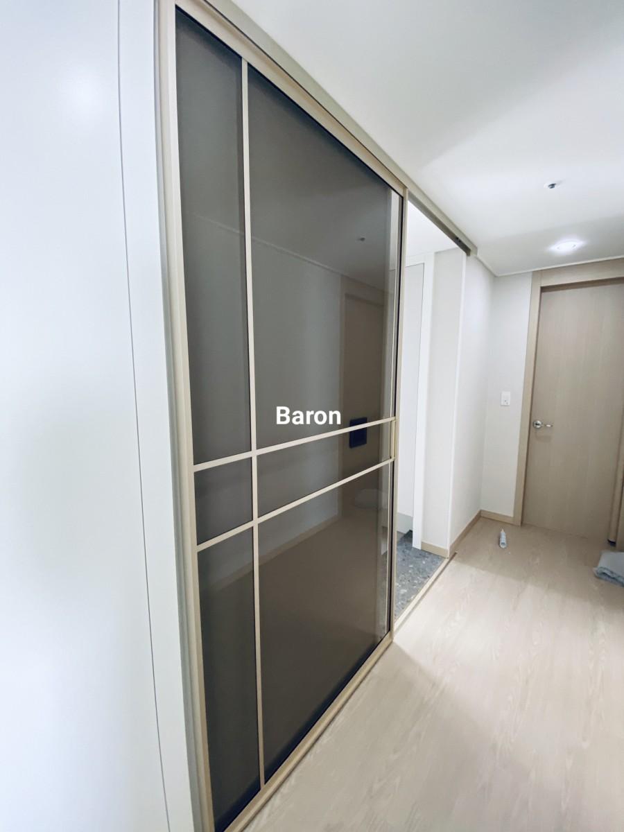 흰색 벽면에 매립 시공이 완료된 샴페인골드 도어